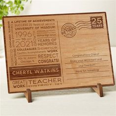 a wooden business card holder with stamps on it