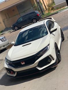 a white car parked in front of a house