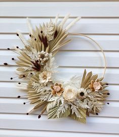 a wreath made out of fake flowers and feathers