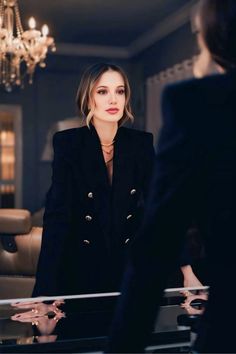 a woman standing in front of a glass table