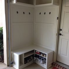 a white bench with shoe storage underneath it