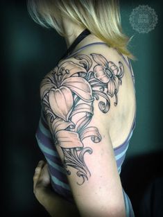 a woman with a tattoo on her shoulder