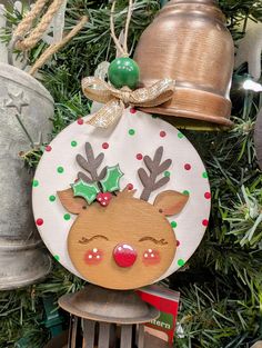 a christmas ornament hanging from the side of a tree with bells on it