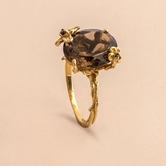 The delicate floral details on this ring surrounds the stunning oval cut smoky quartz to set a statement you didn't know you needed. Approximate stone measurement: 3/8” x 1/2” Finish: 18k gold plated Material: sterling silver, genuine smoky quartz gemstone Item #: 13055 FAIRPRICING $ 115TOORIGINAL | $150 ESTIMATED RETAIL All of our items are priced specially while keeping the same high standard quality. Smokey Quartz Ring, Onyx Engagement Ring, Smoky Quartz Ring, Natural Gold, Quartz Ring, Smoky Quartz, Oval Cut, Black Diamond, Wedding Inspo