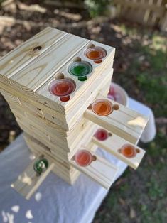 several wooden blocks stacked on top of each other with different colored glass knobs in them