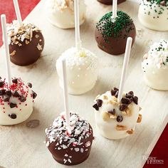 chocolate covered desserts with white and red sprinkles sit on a tray