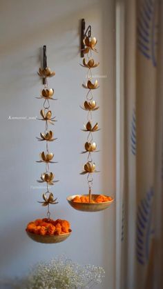 two trays filled with food hanging from the side of a wall next to each other