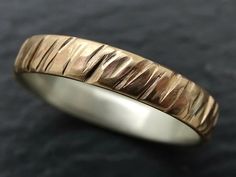 a close up of a gold ring on a black surface