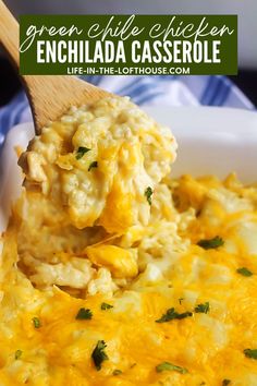 green chile chicken enchilada casserole in a white dish with a wooden spoon