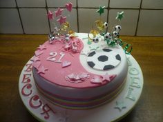 a birthday cake decorated with soccer balls and stars