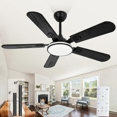 a ceiling fan in the middle of a living room with hardwood floors and white walls