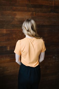 Feel the summer vibes with Jessa In Marigold! This cheerful and lightweight orange top features a flattering ribbed texture, short sleeves, and a fitted style for a perfect fit. Stay stylish and comfortable all day long in this must-have piece. This top is paired with the Marigold Maxi Skirt. Fits true to size. Model is wearing a small and is 5'3". Plus model is wearing an XL and is 5'7". The color in the pic shown with the Marigold Maxi Skirt is more color accurate. Size Chart Length Bust S 21. Fitted Short Sleeve Top With Ribbed Neckline, Summer T-shirt With Ribbed Neckline, Spring Basic Short Sleeve Top With Ribbed Neckline, Basic Short Sleeve Top With Ribbed Neckline For Spring, Fitted Summer T-shirt With Ribbed Neckline, Casual Fitted Short Sleeve Top With Ribbed Neckline, Short Sleeve Orange Top For Loungewear, Athleisure Short Sleeve Tops For Summer, Casual Short Sleeve Top With Ribbed Neckline For Spring