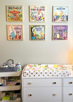 a baby's nursery with posters on the wall