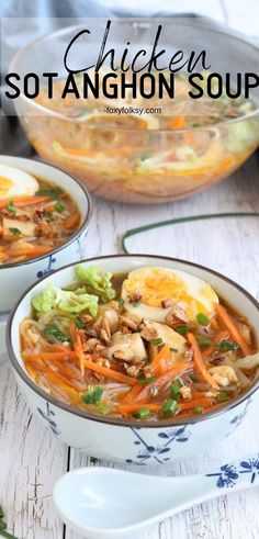 two bowls filled with chicken, carrots and cabbage soup on top of a wooden table