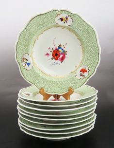 a stack of plates sitting on top of each other in front of a gray background