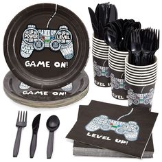 game on party supplies including black plastic cups, forks and napkins with silverware