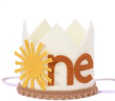 a felt crown with the word one written on it and a sun in the middle