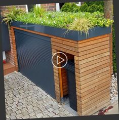 a wooden building with plants growing on top