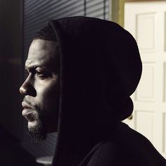 a man wearing a hoodie looking off into the distance