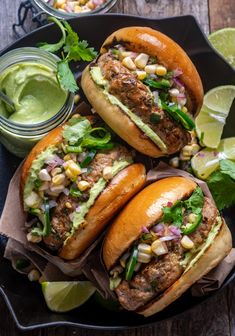 three sandwiches with guacamole, corn and lettuce