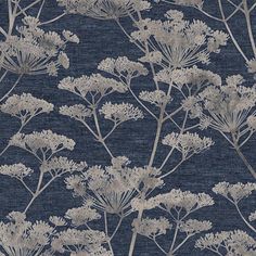 a blue and white floral wallpaper with silver flowers on the top, against a dark background