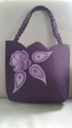 a purple bag with flowers painted on it