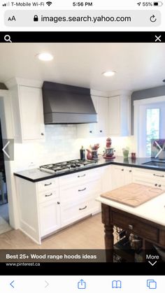 a large kitchen with white cabinets and black counter tops on the island in front of the stove