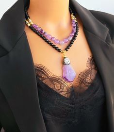 📍 Description :  The handmade necklace has been designed with genuine Amethyst gemstone 11 mm and  Onyx gemstone 8 mm.   💎 Pendant: A raw Amethyst- 6 cm - emboilled with zirkon stones 💥 The colours of the stones may differ slightly in photo shoots caused by lighting and reflections. The necklace is Modern chunky statement gemstone beaded asymetrical necklace for women. The necklace does not stretch and well kept its shape.  ✂ Materials : The natural stones used are;  Amethyst and Onyx Stone Elegant Onyx Beaded Necklace For Healing, Black Amethyst Gemstone Beads Necklace, Black Amethyst Gemstone Beads Jewelry, Elegant Black Amethyst Jewelry, Elegant Black Amethyst Necklace, Black Amethyst 8mm Bead Jewelry, Black Amethyst Beads Jewelry 8mm, Elegant Purple Agate Beaded Necklaces, Elegant Purple Agate Beaded Necklace