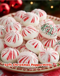 white and red peppermints on a plate next to a christmas tree