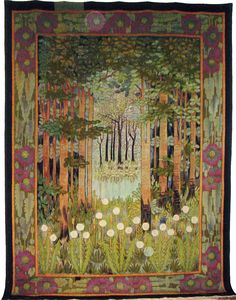 a quilted wall hanging with trees and flowers in the woods on it's side