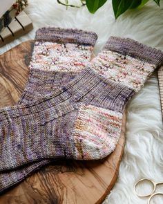 a pair of socks sitting on top of a wooden board