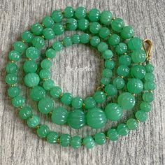 Thank you for coming in!  Breath-taking imperial chrysoprase bead necklace with rare melon carvings and 18k solid gold spacers and clasp, 282 carats of mesmerizing glowing green material and 18k solid gold! Rare and precious! 26.5" long necklace! You'll get the necklace you see! SIZE of the stones: 6.3mm-12.5mm MATERIAL: 18k solid gold, Imperial Chrysoprase Antique Green Beaded Necklace As Gift, Antique Green Beaded Necklace For Gift, Green Single Strand Beads And Cabochons As A Gift, Traditional Green Single Strand Necklace, Handmade Chrysoprase Beaded Necklaces With Round Beads, Emerald Necklace With Chrysoprase Round Beads, Elegant Chrysoprase Gemstone Beads Necklaces, Hand-strung Green Emerald Necklace, Faceted Jade Round Bead Necklace