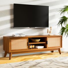 a flat screen tv mounted to the side of a wooden entertainment center in a living room