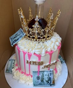 a birthday cake with money and a bottle on the top is decorated in pink and white icing