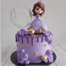 a purple cake with a princess on top