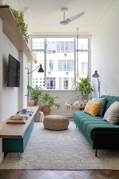 a living room filled with lots of furniture and plants on the windows sills