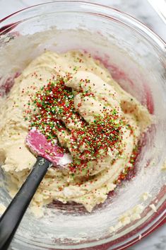 a mixing bowl filled with batter and sprinkles