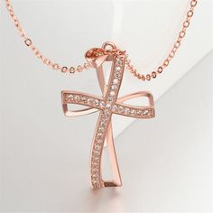 Keep a symbol of your faith close to your heart with this gleaming 18k rose gold-plated cross pendant necklace embellished with glittering crystal accents. Chain : 17.72" L with 1.96" extender Pendant : 0.94" W x 1.69" L 18k rose gold-plated copper / cubic zirconia Snap closure Rose Gold Clavicle Chain Cross Jewelry, Rose Gold Cross Jewelry With Adjustable Chain, Rose Gold Cubic Zirconia Cross Pendant, Rose Gold Cubic Zirconia Cross Necklace, Elegant Rose Gold Crucifix Cross Necklace, Rose Gold Cross Jewelry For Mother's Day, Rose Gold Cubic Zirconia Cross Pendant Necklace, Gift Rose Gold Crucifix Cross Necklace, Rose Gold Pendant Cross Necklace As Gift