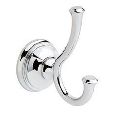 a chrome hook on the side of a white wall