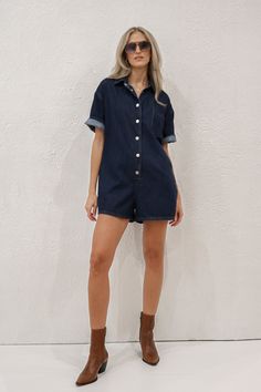 Short sleeve dark wash denim romper. Shift silhouette with a collared neckline and snap button front closure. Relaxed fit. Material: 97% Rayon, 3% Polyester. Sizing: Small: US Size 0-2 Medium: US Size 4-6 Large: US Size 8-10 Model Measurements: Height: 5’11” Chest: 32” Waist: 26” Hips: 36” Wearing size small. Jean Romper, Denim Romper, Dark Wash Denim, Park City, Model Measurements, Snap Button, Size 4, Rompers, Relaxed Fit