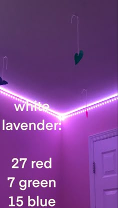 a room with purple walls and lights on the ceiling