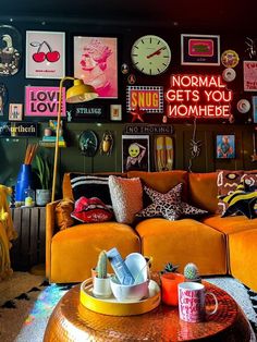 a living room filled with lots of furniture and pictures on the wall above it's coffee table