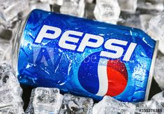 a can of pepsi soda sitting on top of ice cubes with the word pepsi printed on it