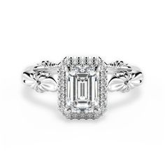 an emerald - cut diamond ring with intricate filigrees on the shoulders and sides