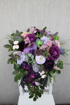 a bouquet of flowers sitting on top of a white table