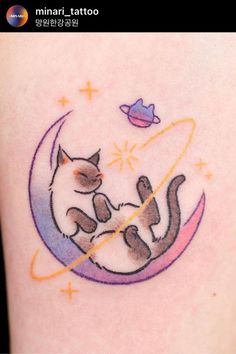 a woman's arm with a cat sitting on the moon and saturn behind her