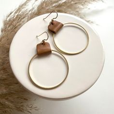 "A circle brass charm hangs from a tan brown leather strap to make the perfect hoop earrings for just about any outfit. They are lightweight on the ears, and a neutral style that will become a favorite go-to pair!  * 2.5\"L x 1.5\" W * 14kt gold filled ear wire. Nickel free * brass circle charm with genuine leather * lightweight More colors available here: https://www.etsy.com/listing/1320410071/leather-and-brass-hoop-earrings-leather ❤️ All of my earrings are packaged with care and attention to Brown Small Hoop Earrings With Ear Wire, Minimalist Brown Hoop Earrings For Everyday, Everyday Brass Circle Earrings, Everyday Brass Circular Earrings, Everyday Circular Brass Earrings, Handmade Brown Hoop Earrings For Everyday Wear, Everyday Handmade Brown Hoop Earrings, Brown Hoop Earrings With Ear Wire, Brown Single Hoop Earring As Gift