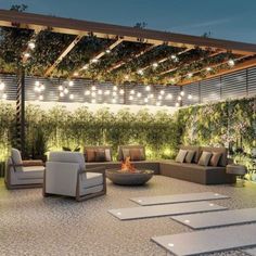 an outdoor living area with couches, tables and lights hanging from the pergolated roof