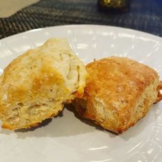 two biscuits sitting on top of a white plate