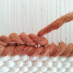 two skeins of yarn sitting next to each other on a weaving loom